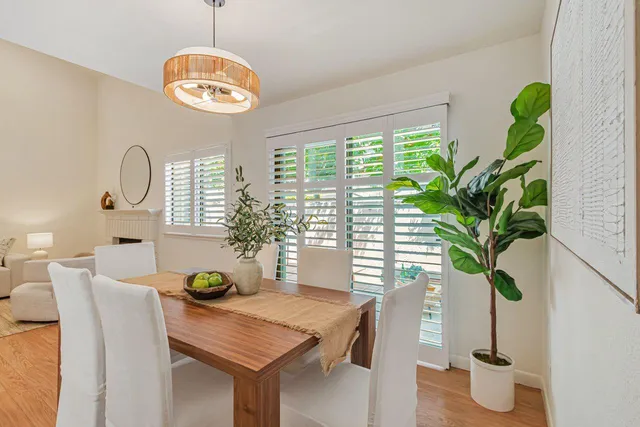 a view of a dining room with furniture and chandelier