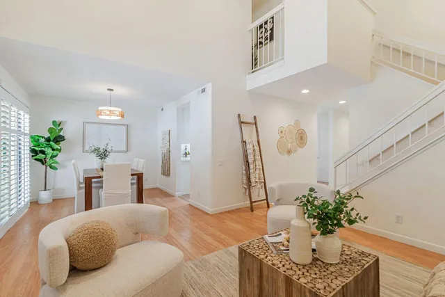 a living room with furniture potted plant and a chandelier