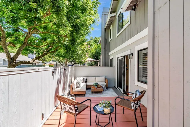a backyard of a house with table and chairs
