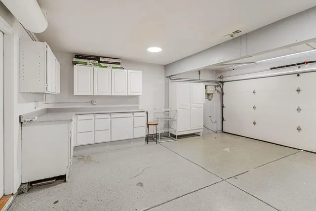 a view of a kitchen with white cabinets and white appliances