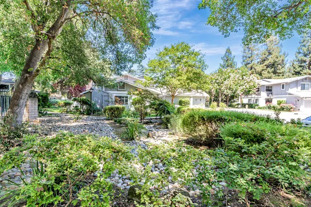 a view of backyard of house with green space