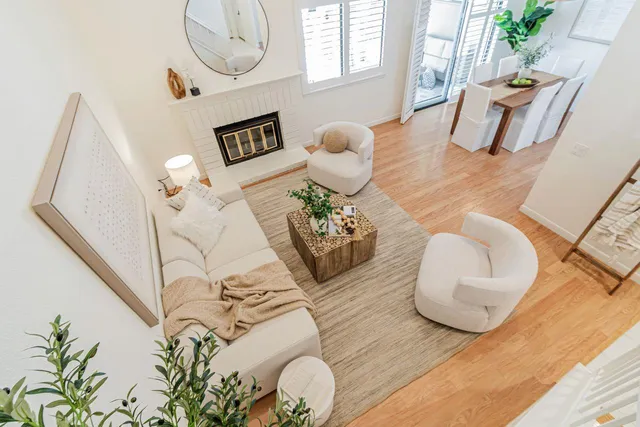 a living room with furniture potted plant and wooden floor