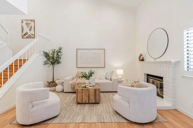 a living room with furniture and a potted plant