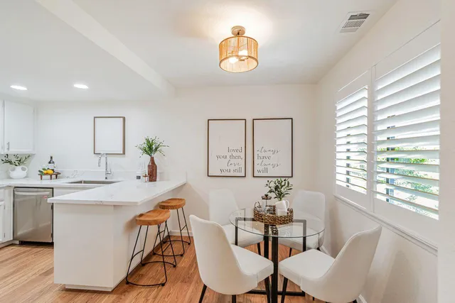 a view of a dining room with furniture window and wooden floor