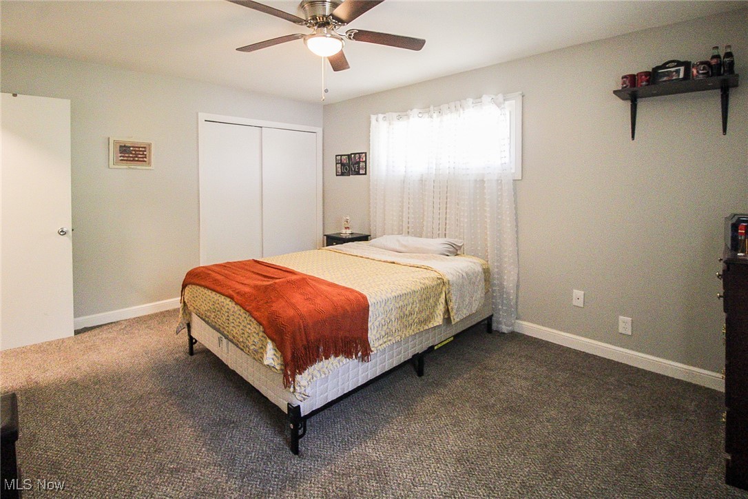 3267 South Leavitt Road Southwest Warren, OH 44481 - Photo 24 of 45 Carpeted bedroom featuring a ceiling fan and a closet