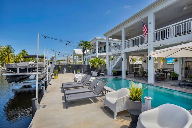 a living room with furniture and a dining table