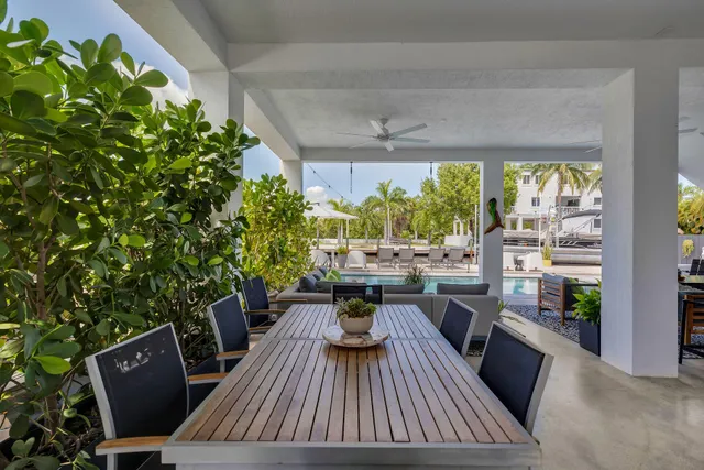 a kitchen with granite countertop a stove a sink and a refrigerator