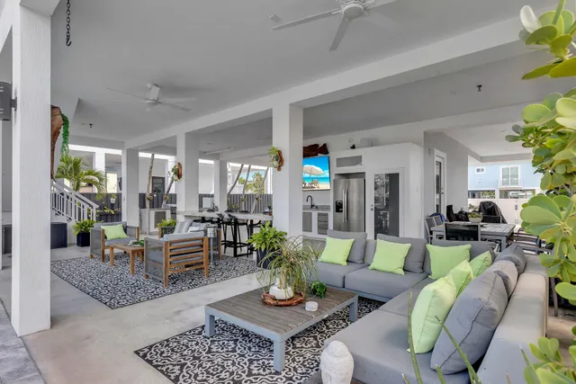 a view of a dining room with furniture a chandelier and wooden floor