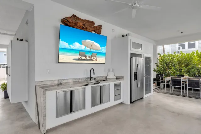 a kitchen with kitchen island granite countertop a stove cabinets and microwave with wooden floor