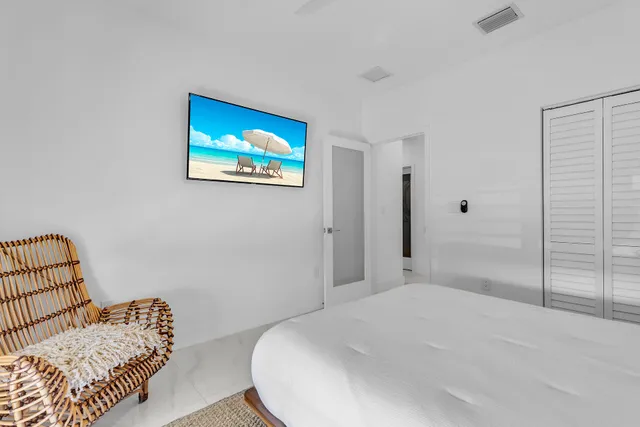 a bathroom with a glass shower door and a mirror