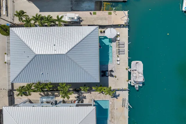a front view of a house with swimming pool having outdoor seating
