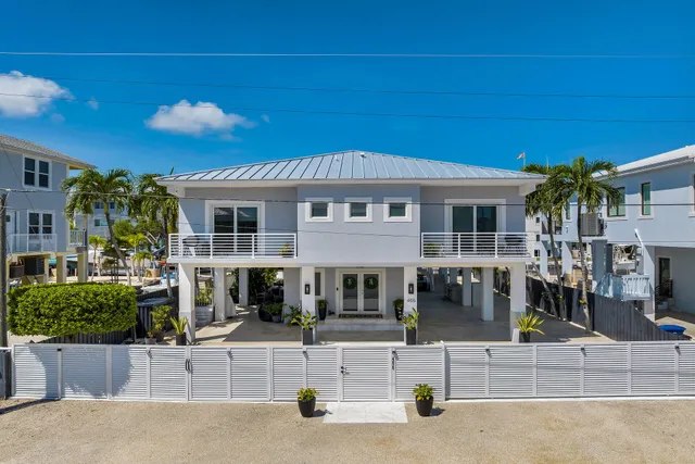 a view of a patio with couches table and chairs potted plants and palm tree