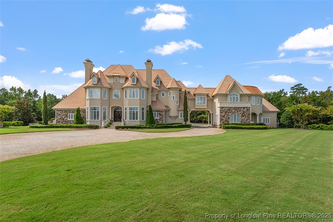 a front view of a house with a garden and plants