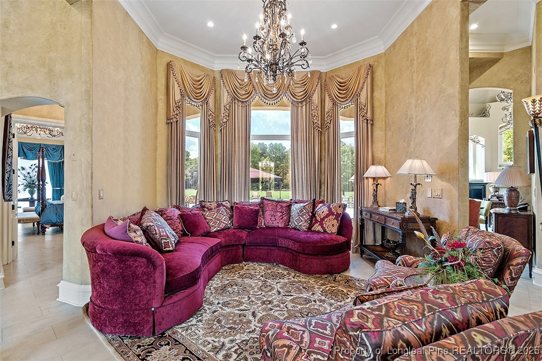 4909 Deep Branch Road Pembroke, NC 28372 - Photo 15 of 50 a living room with furniture chandelier and large windows