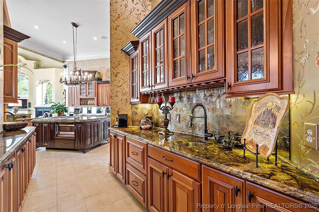 4909 Deep Branch Road Pembroke, NC 28372 - Photo 17 of 50 a kitchen with stainless steel appliances granite countertop a sink and a stove next to a window