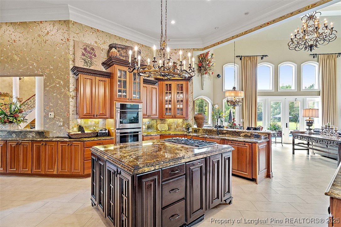 4909 Deep Branch Road Pembroke, NC 28372 - Photo 19 of 50 a kitchen with stainless steel appliances granite countertop a stove and a center island