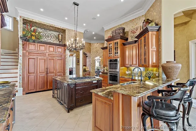a kitchen with stainless steel appliances granite countertop a stove a sink and a refrigerator