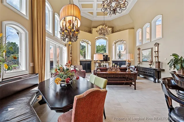 a living room with furniture chandelier and a large window