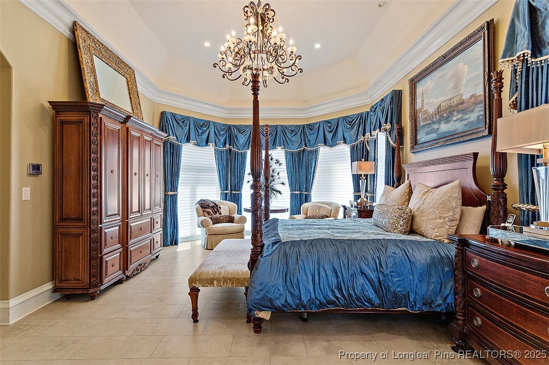 4909 Deep Branch Road Pembroke, NC 28372 - Photo 26 of 50 a bedroom with furniture and a chandelier