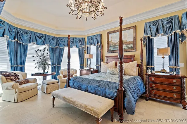 a bedroom with furniture and large windows