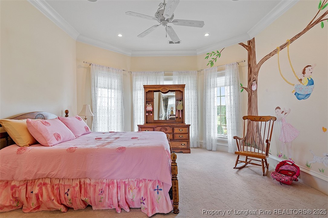 4909 Deep Branch Road Pembroke, NC 28372 - Photo 38 of 50 a bedroom with a bed and a chandelier
