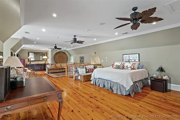 a bedroom with furniture and a mirror
