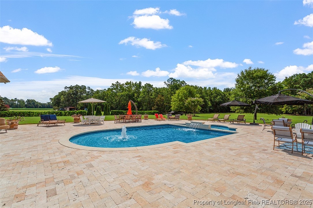 4909 Deep Branch Road Pembroke, NC 28372 - Photo 7 of 50 a view of a swimming pool and sitting area