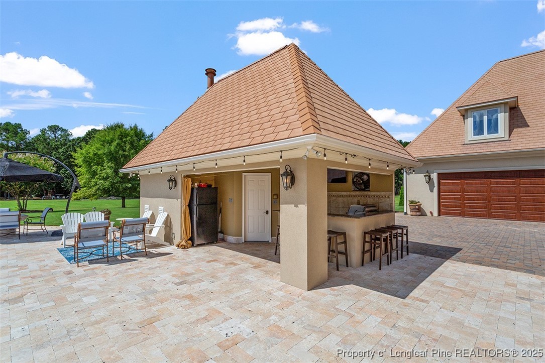 4909 Deep Branch Road Pembroke, NC 28372 - Photo 9 of 50 a view of a house with backyard porch and sitting area