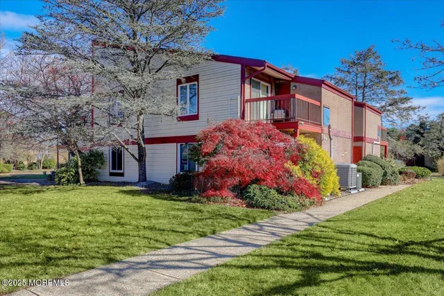 a front view of house with yard and trees