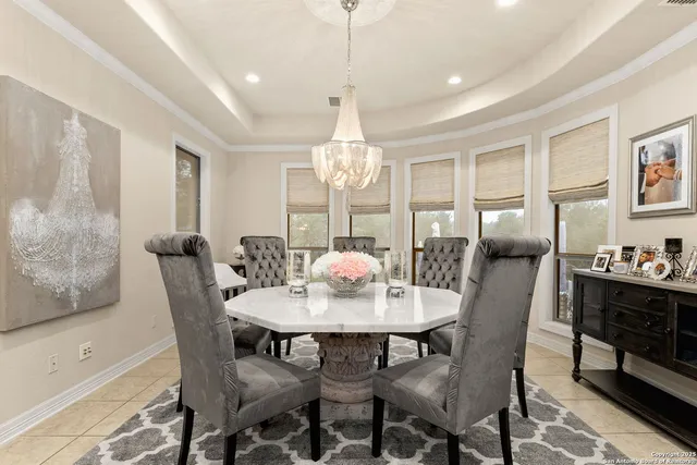 a dining room with furniture a chandelier and window
