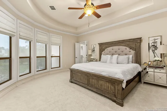 a spacious bedroom with a bed and large window