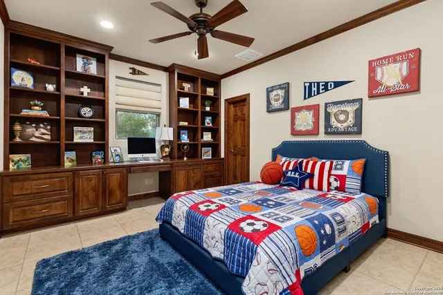 a bedroom with a large bed and a chandelier