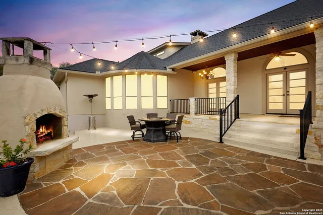 a view of a patio with a dining table and chairs with wooden floor