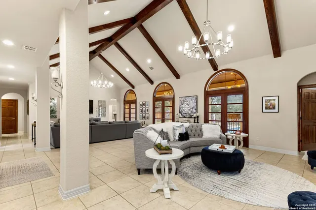 a living room with furniture and a chandelier