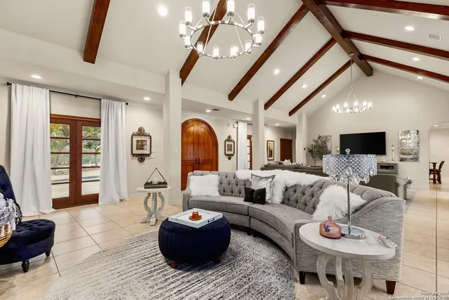 a living room with furniture and a chandelier
