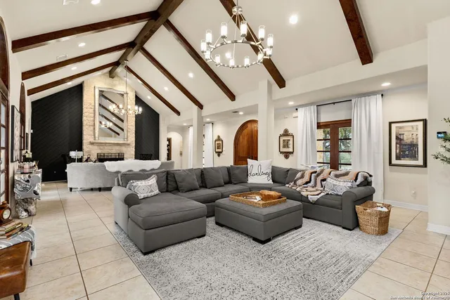 a living room with furniture and a chandelier
