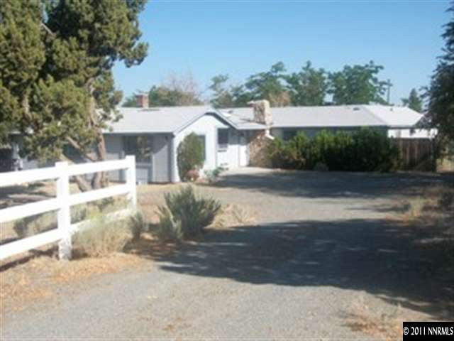 1595 Short Ridge Drive Reno, NV 89521 - Photo 2 of 12 a view of a white house with a yard