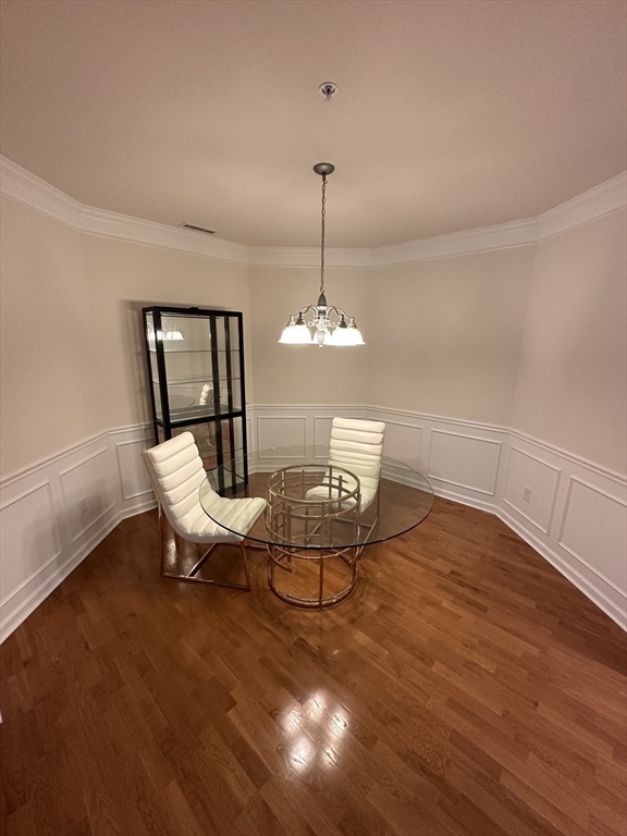 428 John Mahar Highway, Unit 301 Braintree, MA 02184 - Photo 13 of 41 a dining room with furniture a chandelier and wooden floor