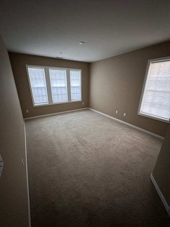 428 John Mahar Highway, Unit 301 Braintree, MA 02184 - Photo 14 of 41 an empty room with windows
