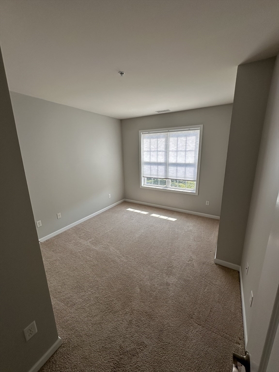 428 John Mahar Highway, Unit 301 Braintree, MA 02184 - Photo 18 of 41 an empty room with a window