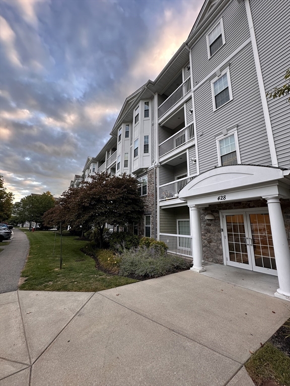 428 John Mahar Highway, Unit 301 Braintree, MA 02184 - Photo 2 of 41 a front view of a building with garden