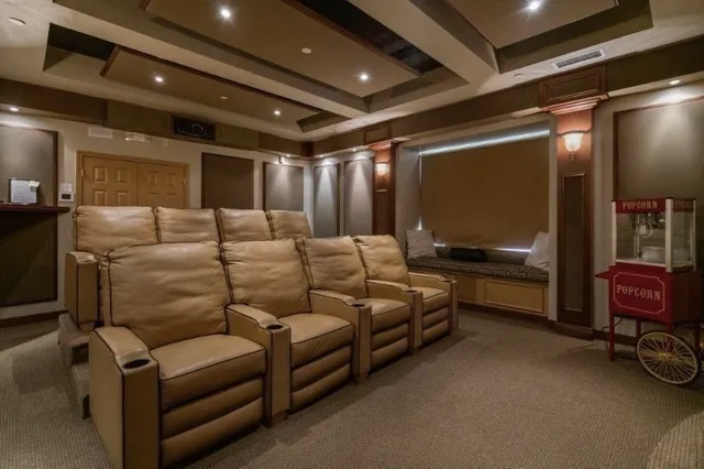 a media room with lots of chairs and a projector