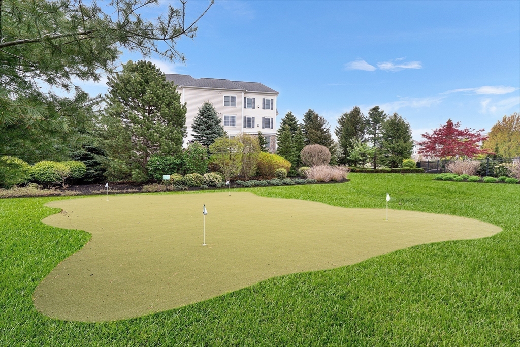 428 John Mahar Highway, Unit 301 Braintree, MA 02184 - Photo 38 of 41 a view of a house with a yard and basketball court