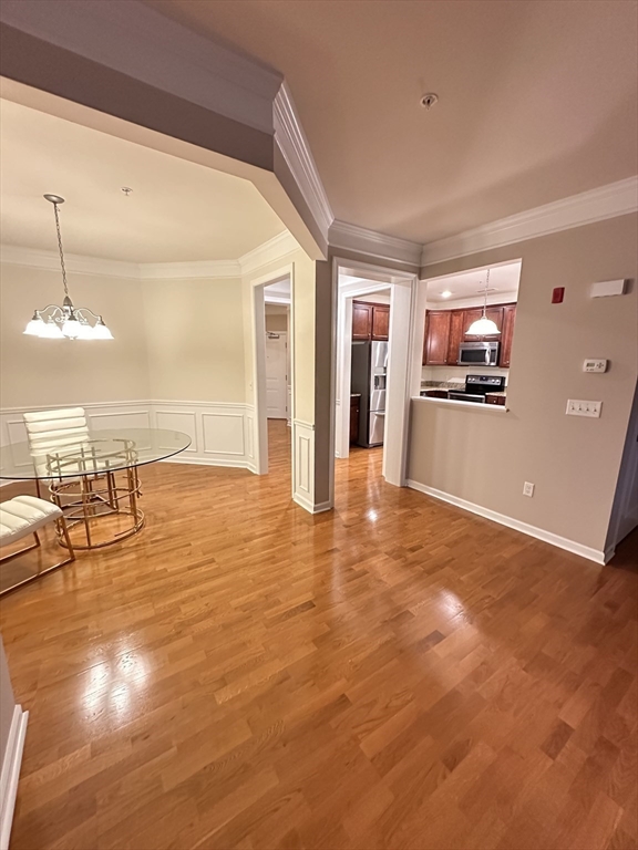 428 John Mahar Highway, Unit 301 Braintree, MA 02184 - Photo 7 of 41 wooden floor in an empty room with window