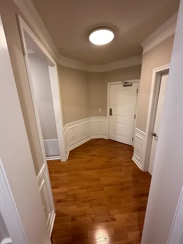 a view of empty room with wooden floor