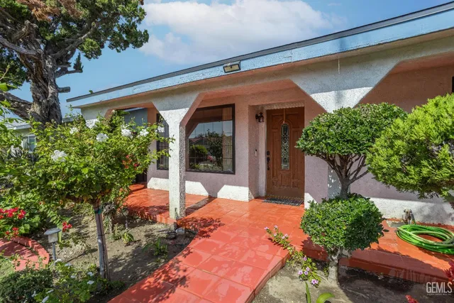 a backyard of a house with outdoor seating and green space