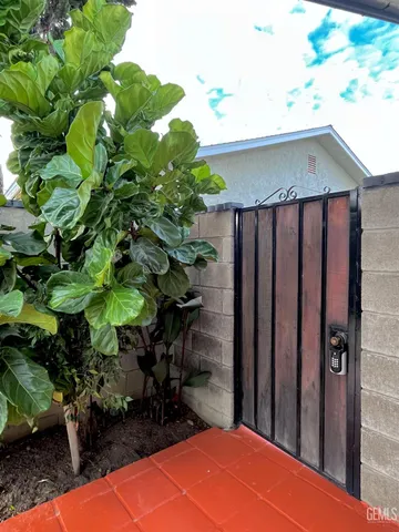 a backyard of a house with table and chairs