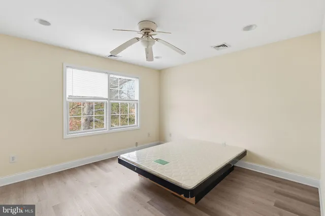 a room with a chair and frames on the wall