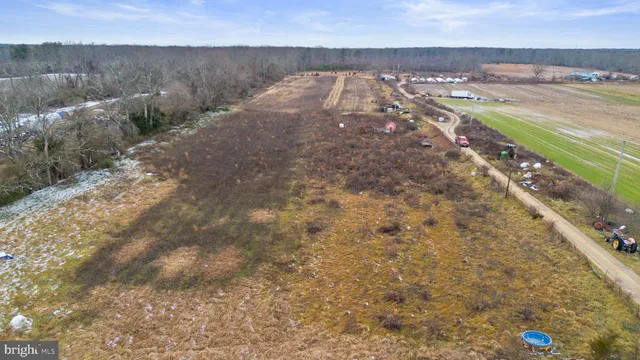 an aerial view of a house with a yard and wooden fence