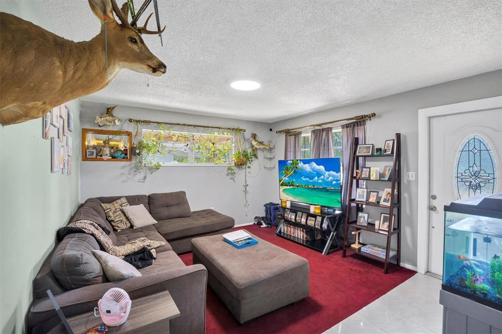 517 Marianna Road Auburndale, FL 33823 - Photo 15 of 37 a living room with furniture and a flat screen tv